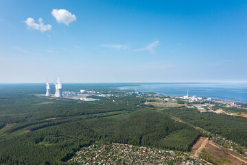 Fototapeta na wymiar Smoking cooling towers at nuclear power plant located on seaside. Aerial view