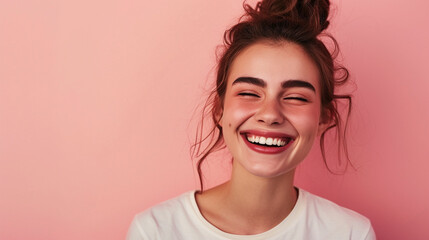 A cheerful, accomplished woman dressed casually, beaming with joy and self-assurance, standing against a soft pink background. Her expression is one of genuine happiness and confidence. - obrazy, fototapety, plakaty