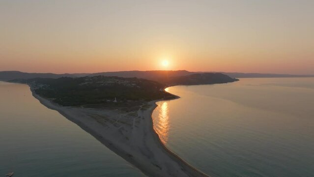 Drone captures the peaceful dawn retreating over the sandy beach of Possidi Cape in Halkidiki, Greece