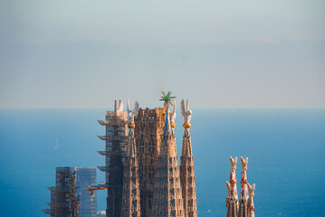 Closeup of Sagrada Familia spires in Barcelona, showing Gaudi's Modernisme with geometric decor and...