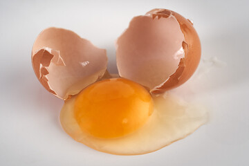 Broken chicken egg on white