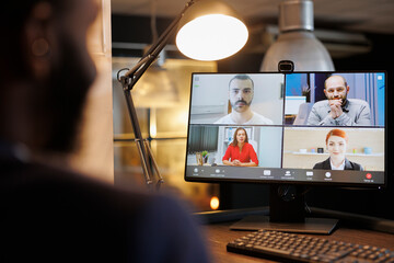 Manager discussing financial graph with remote colleagues during online videocall meeting...