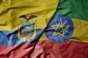big waving national colorful flag of ethiopia and national flag of ecuador .