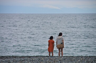 Sisters looking at the sea