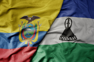 big waving national colorful flag of lesotho and national flag of ecuador .
