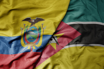 big waving national colorful flag of mozambique and national flag of ecuador .