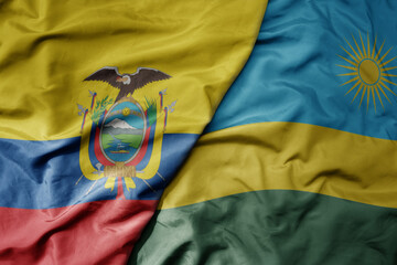 big waving national colorful flag of rwanda and national flag of ecuador .