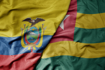 big waving national colorful flag of togo and national flag of ecuador .