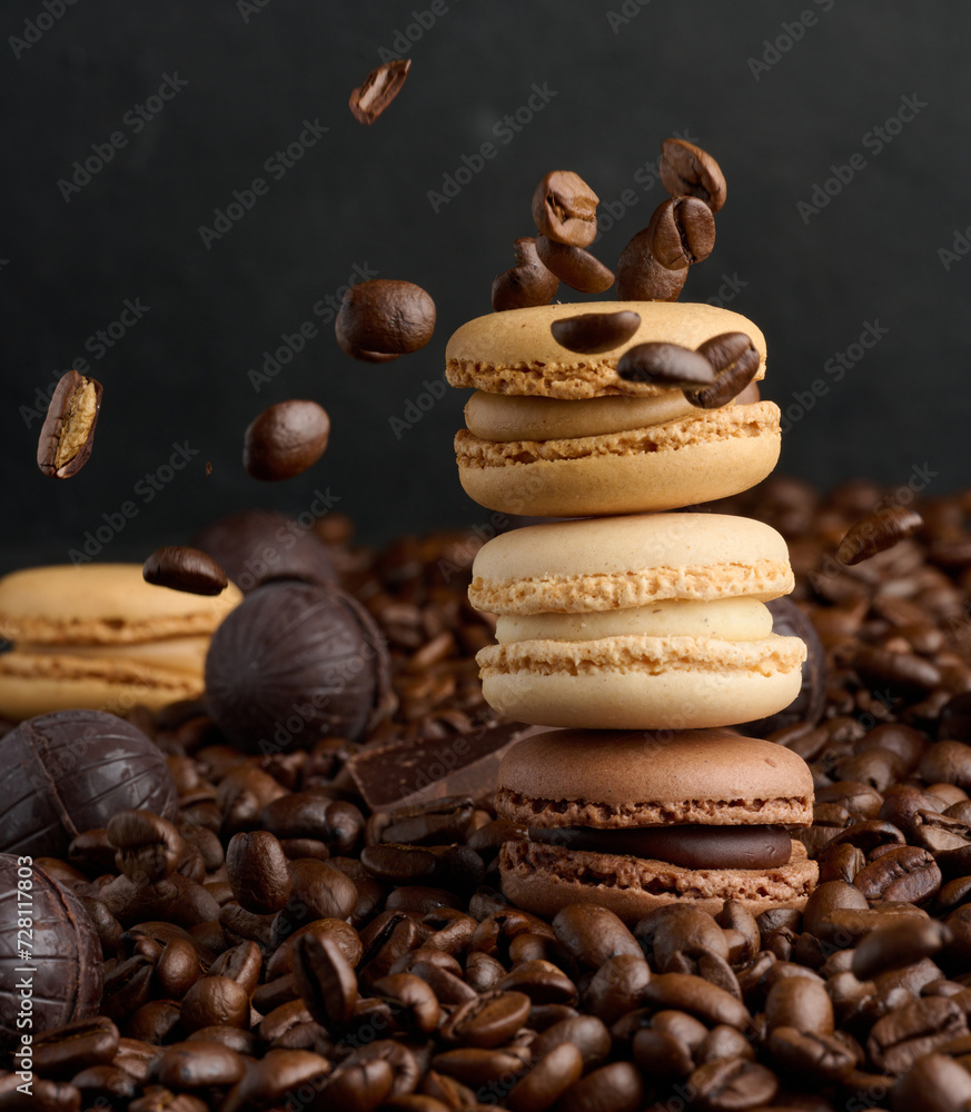 Poster stack of multi-colored macarons on a background of coffee beans, black background