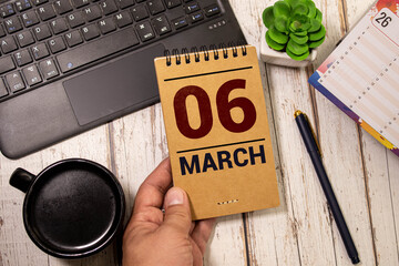 6 March on wooden grey cubes. Calendar cube date 06 March. Concept of date. Copy space for text or...