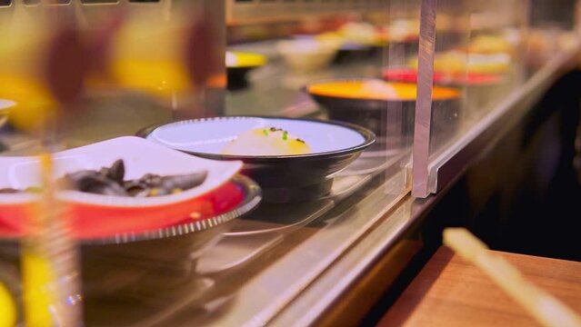 Vibrant Conveyor Belt Sushi Experience at a Bustling Restaurant