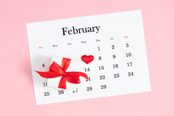 Valentine's Day background. Date February 14 on calendar 2024. Gift box and valentine hearts. Valentines day concept. Flat lay, top view, copy space