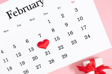 Valentine's Day background. Date February 14 on calendar 2024. Gift box and valentine hearts. Valentines day concept. Flat lay, top view, copy space