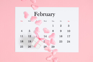 Valentine's Day background. Date February 14 on calendar 2024. Gift box and valentine hearts....