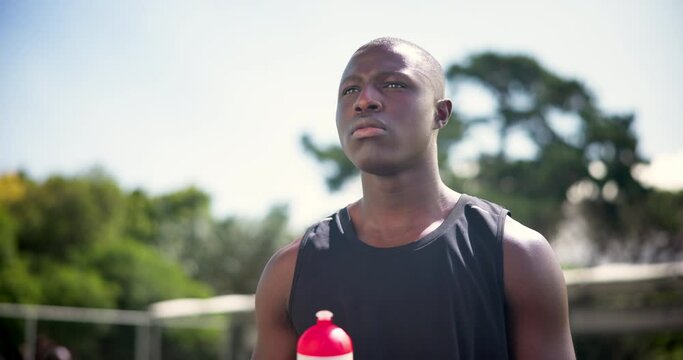 Man, drink and water for outdoor sport, outside and body for competition or fitness game. Athlete, thirst and pouring health liquid in mouth, hydration and basketball training in summer for exercise
