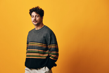 Portrait man smile fashion hispanic sweater winter orange background happy trendy student
