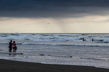 People enjoying wild waves at the sea