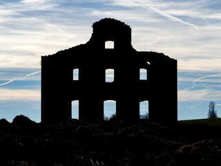 Silhouette of the skeleton of an old adobe house in Tierra de Campos. Castromocho, Palencia, Spain.