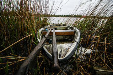 a boat on the shore, on the shore of the lake, oars in the boat
