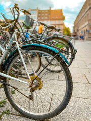 Row of Bicycles Parked in the Town Square. Numerous bicycles parked in a row on in the town square...