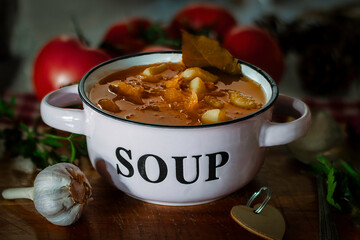 hearty homemade soup in a  bowl on the wooden table