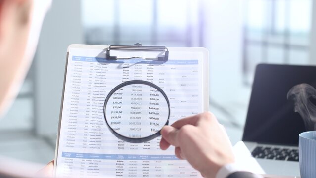 A document verification, magnifying glass, important report