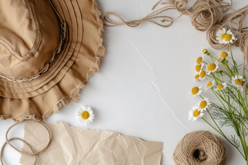 Top view hat and paper with daisy and twine on the table, Minimal fashion summer holiday concept. Flat lay