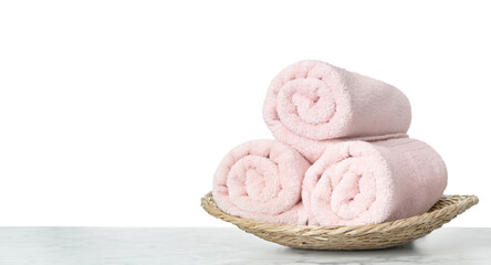 Fresh bath towels on table against white background. Space for text