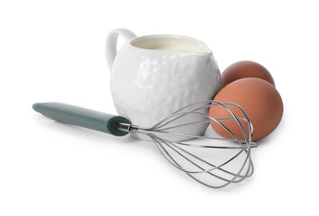 Whisk, raw eggs and jug of milk isolated on white