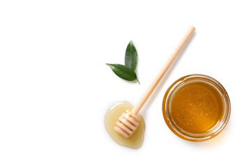 Tasty honey in glass jar, leaves and dipper on white background, flat lay. Space for text