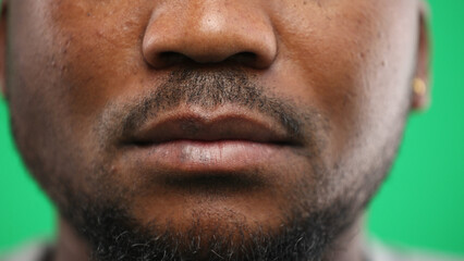 Man's mouth, close-up, on a green background