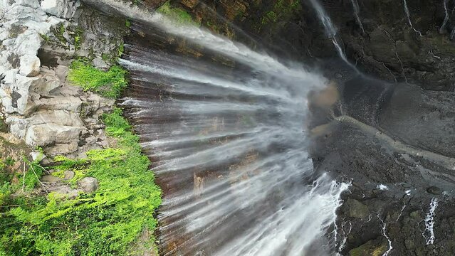 Vertical format: Stunning Tumpak Sewu waterfall in tall Java canyon