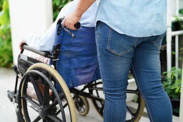 Obraz premium Caregiver help Asian elderly woman disability patient sitting on wheelchair in hospital, medical concept.