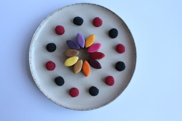 Rainbow candies with raspberries