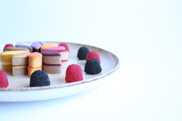 Rainbow candies with raspberries