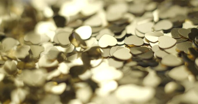 Heart sequins golden falling close up, studio 4K