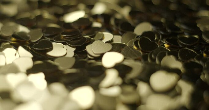 Heart sequins golden rotating close up, studio 4K