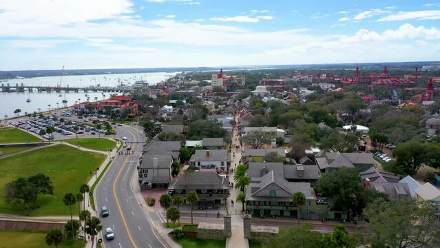Aerial, 4k Shot flying over Saint George Street in St Augustine, Florida with people shopping, eating and drinking at restaurants and bars on a beautiful day in January 2024.