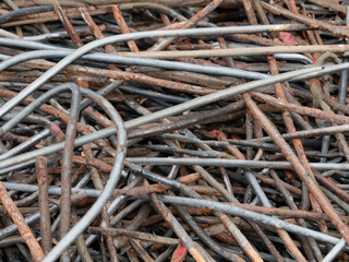 a pile of rusty metal rods on the ground