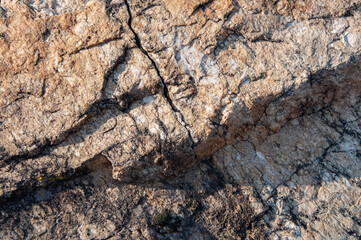 Texture of cracked grey rock