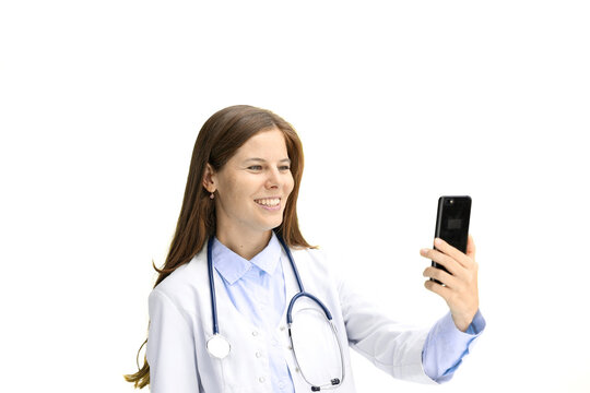 Female doctor, close-up, on a white background, with a phone