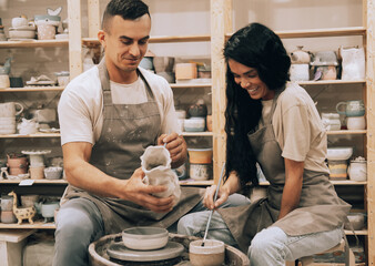 A young couple is engaged in creativity in a pottery workshop