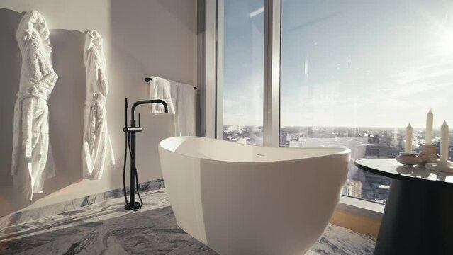 a gorgeous luxury bathroom with a white free standing tub and a side table in a high rise condo