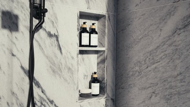 shower accessories in a white granite shower including shampoo conditioner and body wash, push in shot