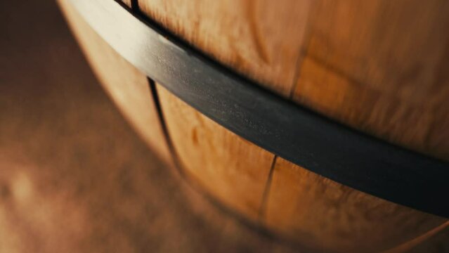 closeup macro shot of a whiskey or wine barrel as the camera pushes down the barrel