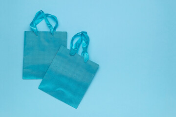 Two gift bags on a blue background.