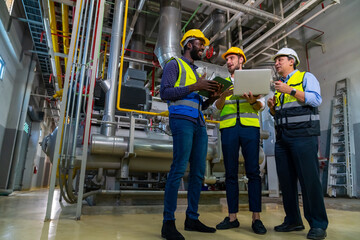 Group of Diversity electrical engineer in safety uniform working together at factory site control...