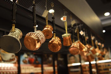 Kitchenware pots and jugs hanging from the ceiling in the cafe