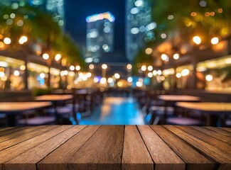 Empty wooden table top with blur background of restaurant at night