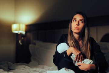 Tired Mother Comforting Little Baby Late at Night. New mom having many sleepless nights feeling...